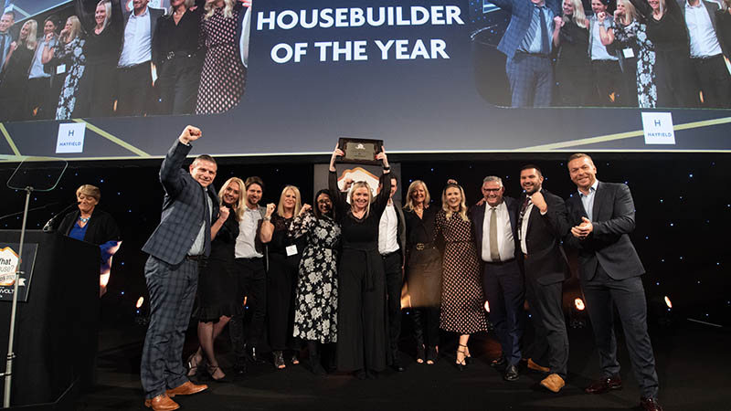 The Hayfield team accepts its WhatHouse? Award