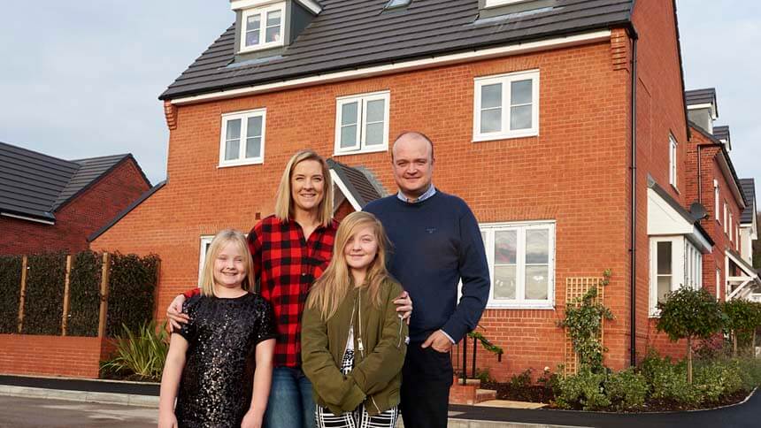 The Andrews' family outside their new home