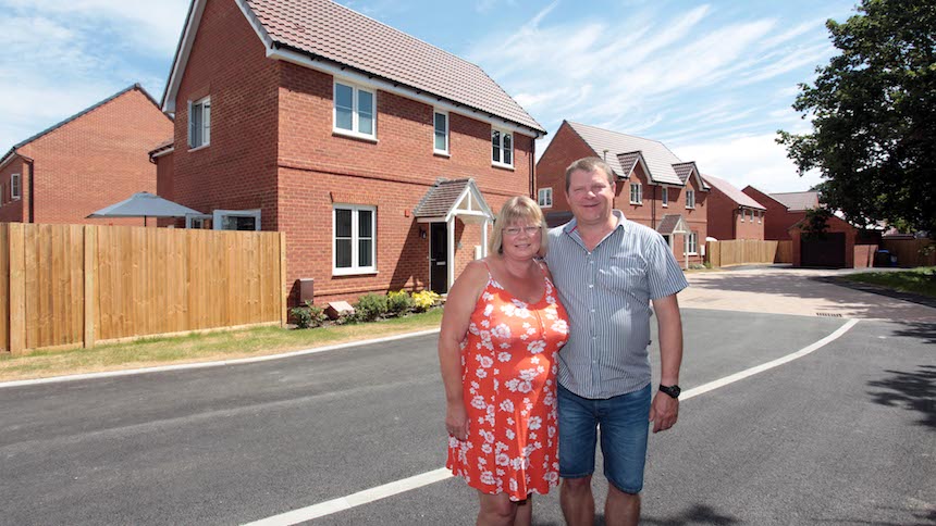 Neil and Vivienne outside their new home