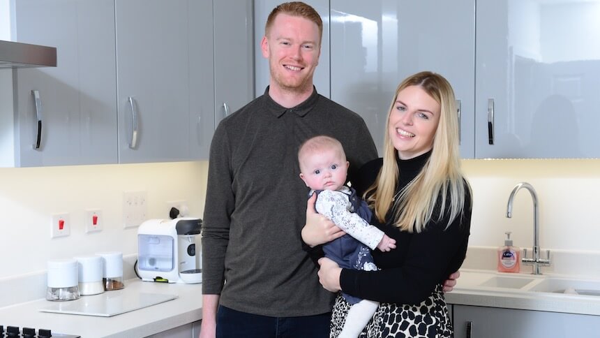 Sophie, Matt and their baby in their new home